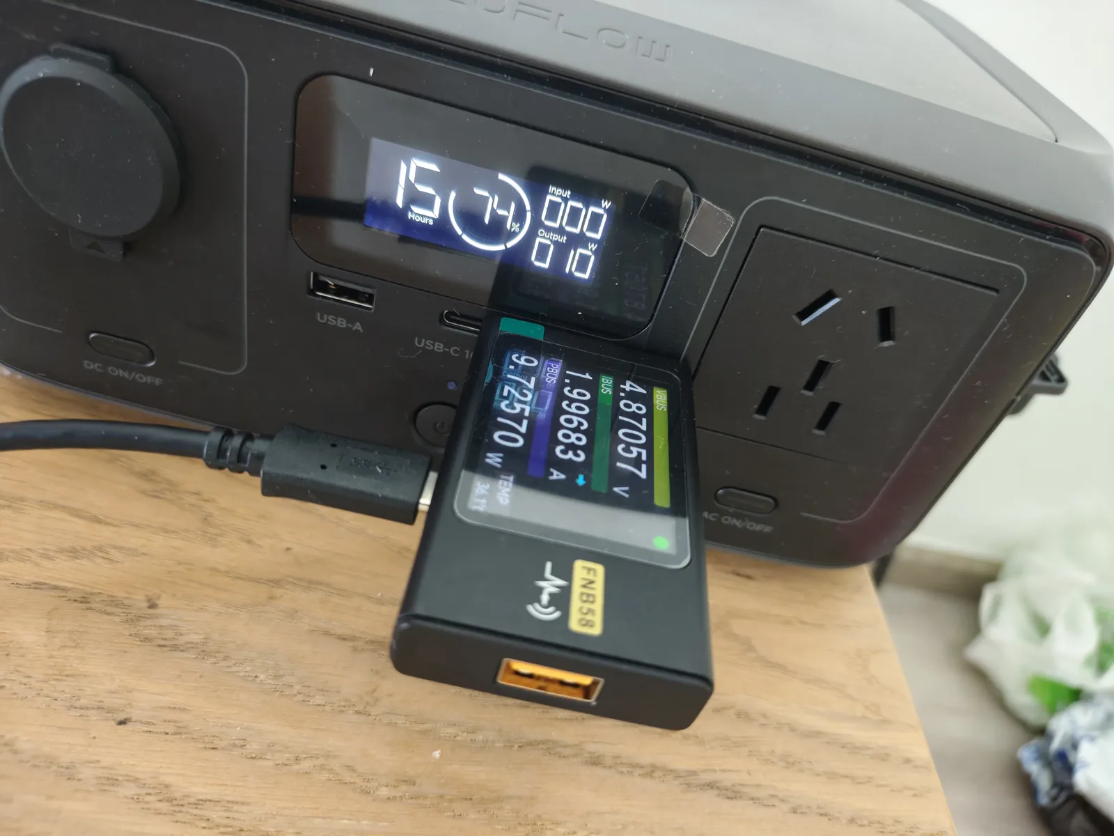 FNB58 USB power meter plugged into the EcoFlow RIVER 3 USB-A port reading 4.87V and 9.73W during a 10-minute stability load test